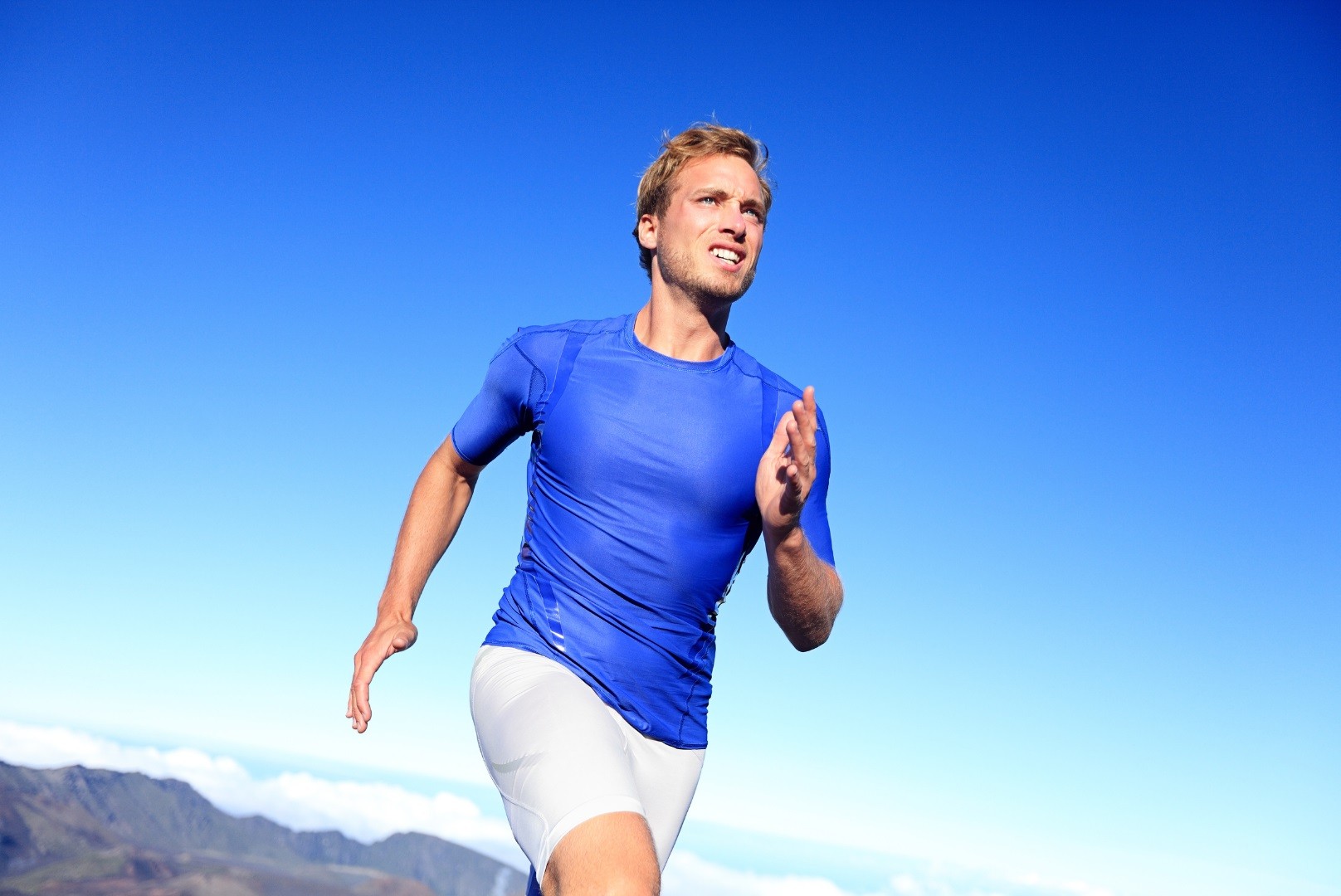 Male athlete stretching before jogging